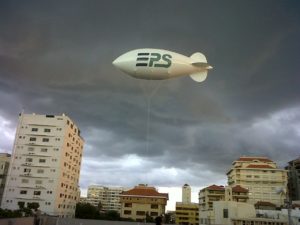 white color advertising blimp in sky